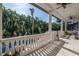 Covered porch with stone flooring, balustrades, and pool view at 5020 W Dickens Ave, Tampa, FL 33629