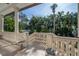 Covered porch with stone flooring, balustrades, and a bird bath at 5020 W Dickens Ave, Tampa, FL 33629