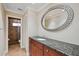 Bathroom with granite vanity and large mirror at 513 Suwanee Cir, Tampa, FL 33606