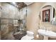 Bathroom with a walk-in shower, pedestal sink, and oval mirror at 513 Suwanee Cir, Tampa, FL 33606