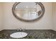 Elegant bathroom sink with granite countertop and ornate mirror at 513 Suwanee Cir, Tampa, FL 33606