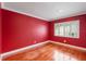 Bright bedroom with red walls and hardwood floors at 513 Suwanee Cir, Tampa, FL 33606