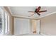 Bedroom with ceiling fan, window shutters, and closet at 513 Suwanee Cir, Tampa, FL 33606