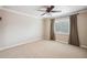 Spacious bedroom with carpeted floor, ceiling fan, and window coverings at 513 Suwanee Cir, Tampa, FL 33606