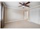 Bright bedroom with neutral walls, ceiling fan, and double door closet at 513 Suwanee Cir, Tampa, FL 33606