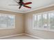 Bright bedroom with ceiling fan, window shutters, and carpet at 513 Suwanee Cir, Tampa, FL 33606