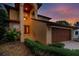 Two-story house with a brown garage door and landscaped yard at dusk at 513 Suwanee Cir, Tampa, FL 33606