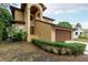 Two-story house with a brown garage door and well-manicured hedges at 513 Suwanee Cir, Tampa, FL 33606