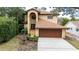 Two-story house with a brown garage door and a fountain in the front at 513 Suwanee Cir, Tampa, FL 33606