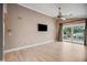 Bright Gathering room featuring hardwood floors, sliding doors, and a ceiling fan at 513 Suwanee Cir, Tampa, FL 33606