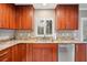 Kitchen with granite countertops, stainless steel appliances, and wood cabinets at 513 Suwanee Cir, Tampa, FL 33606