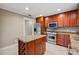 Eat-in kitchen with granite island, stainless steel appliances, and wood cabinets at 513 Suwanee Cir, Tampa, FL 33606