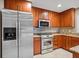 Kitchen boasts stainless steel appliances and wood cabinets at 513 Suwanee Cir, Tampa, FL 33606