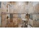 Walk-in shower with stone tile and glass enclosure at 513 Suwanee Cir, Tampa, FL 33606