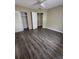 Spacious bedroom with wood-look flooring and ceiling fan at 5130 Dr Martin Luther King Jr St S, St Petersburg, FL 33705