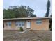 Tan single story house with white door and small yard at 5130 Dr Martin Luther King Jr St S, St Petersburg, FL 33705