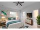 Bright bedroom with a queen-size bed, dresser, and walk-in closet at 528 Rose Apple Cir, Port Charlotte, FL 33954