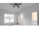 Bright bedroom with ceiling fan and walk-in closet at 528 Rose Apple Cir, Port Charlotte, FL 33954