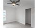 Simple bedroom with ceiling fan and closet at 528 Rose Apple Cir, Port Charlotte, FL 33954