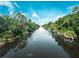 Serene canal view with lush vegetation at 528 Rose Apple Cir, Port Charlotte, FL 33954