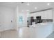 Modern kitchen with white cabinets, stainless steel appliances, and a breakfast bar at 528 Rose Apple Cir, Port Charlotte, FL 33954