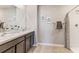 Double vanity bathroom with shower and decorative accents at 5330 Oxford Gray Rd, Wesley Chapel, FL 33545