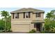 Two-story house with beige exterior, brown accents, and a two-car garage at 5330 Oxford Gray Rd, Wesley Chapel, FL 33545