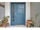 Blue front door with sidelights and potted plants at 5720 107Th E Ter, Parrish, FL 34219