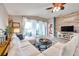 Bright living room with a comfortable sectional sofa, a wood accent wall, and a view of a patio at 5720 107Th E Ter, Parrish, FL 34219