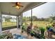 Relaxing screened porch with ceiling fan and potted plants at 5720 107Th E Ter, Parrish, FL 34219