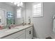 Bathroom with double vanity and updated light fixtures at 6205 Voyagers Pl, Apollo Beach, FL 33572