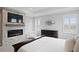 Elegant main bedroom with fireplace, large TV, and plantation shutters at 6205 Voyagers Pl, Apollo Beach, FL 33572