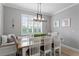 Light-filled dining area featuring a rustic wooden table at 6205 Voyagers Pl, Apollo Beach, FL 33572