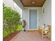 Inviting front entry with a gray door and a wooden bench at 6205 Voyagers Pl, Apollo Beach, FL 33572