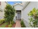 House entrance with a blue door and brick pathway at 6205 Voyagers Pl, Apollo Beach, FL 33572