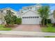 Two story house with a white garage door and landscaping at 6205 Voyagers Pl, Apollo Beach, FL 33572