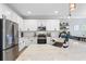 Modern kitchen with white cabinets, quartz countertops, and stainless steel appliances at 6205 Voyagers Pl, Apollo Beach, FL 33572