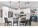 Modern kitchen with white cabinets, quartz countertops, and an island at 6205 Voyagers Pl, Apollo Beach, FL 33572