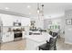 Modern kitchen with white cabinets, quartz countertops, and an island at 6205 Voyagers Pl, Apollo Beach, FL 33572