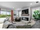 Relaxing living room with fireplace, sectional sofa, and sliding glass doors to patio at 6205 Voyagers Pl, Apollo Beach, FL 33572