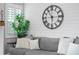 Living room with gray sectional sofa and large clock on shiplap wall at 6205 Voyagers Pl, Apollo Beach, FL 33572