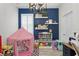 Playroom featuring navy walls, built-in shelving, and a play tent at 6205 Voyagers Pl, Apollo Beach, FL 33572