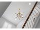 Elegant chandelier illuminating a bright stairwell at 6205 Voyagers Pl, Apollo Beach, FL 33572