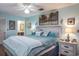 Spacious Primary bedroom with light blue color scheme and large bed at 6432 Remus Dr, New Port Richey, FL 34653