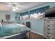 Bedroom with large bed, ceiling fan, and light blue walls at 6432 Remus Dr, New Port Richey, FL 34653