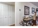 Bright hallway with white louvered doors and decorative console table at 6432 Remus Dr, New Port Richey, FL 34653