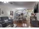 Bright living room with hardwood floors, and a view into the kitchen and dining area at 6432 Remus Dr, New Port Richey, FL 34653