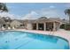 Inviting community pool and relaxing covered patio area at 6432 Remus Dr, New Port Richey, FL 34653