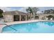 Community pool with covered seating area and lounge chairs at 6432 Remus Dr, New Port Richey, FL 34653