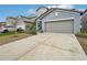 Two-story house with gray exterior, two-car garage, and landscaping at 656 Argyll Dr, Spring Hill, FL 34609